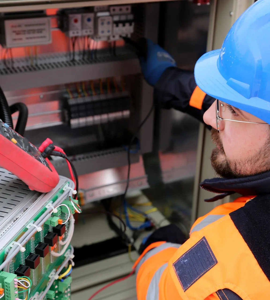 Electrician wiring a residential breaker panel