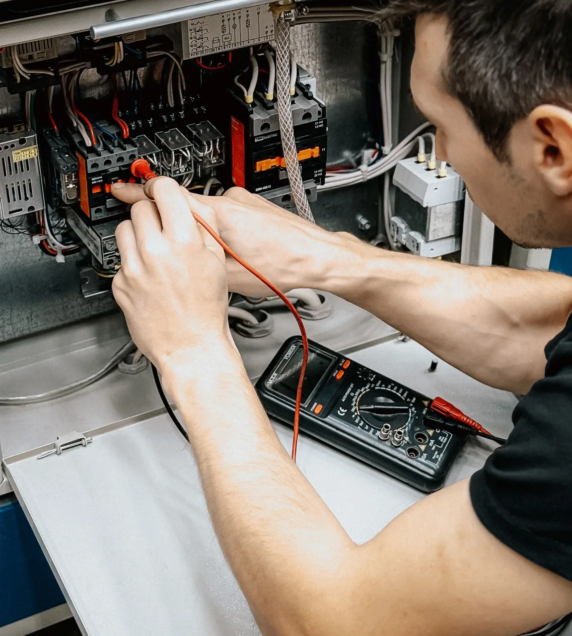 Electrician wiring a residential breaker panel